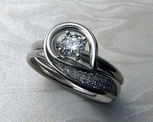 Solitaire engagement ring with very unusual band.