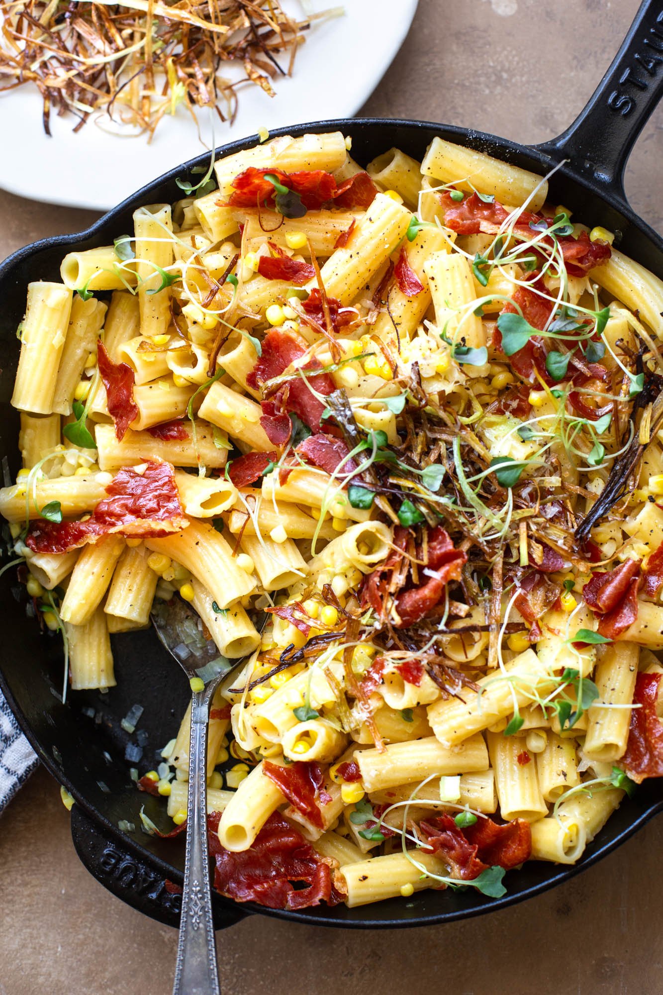 Summer pasta dish with corn, leeks, and crispy prosciutto.