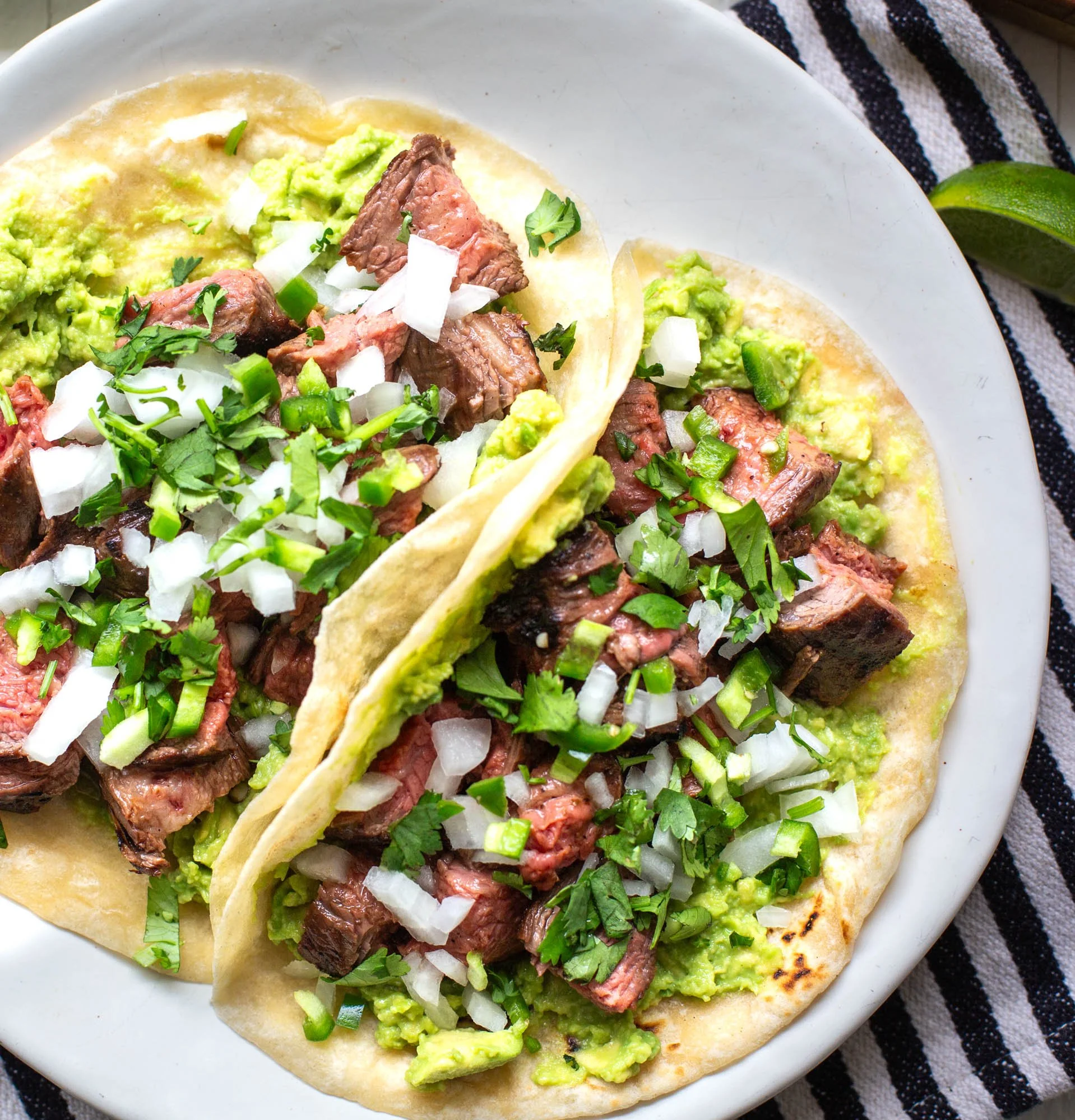 Plated close up of carne asada tacos.