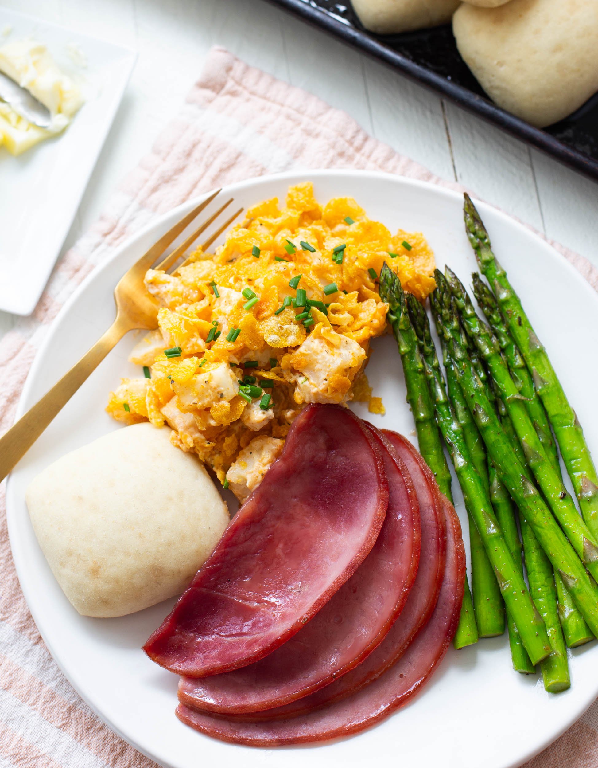 Glazed ham, potato casserole, asparagus, and rolls make a beautiful Easter dinner.