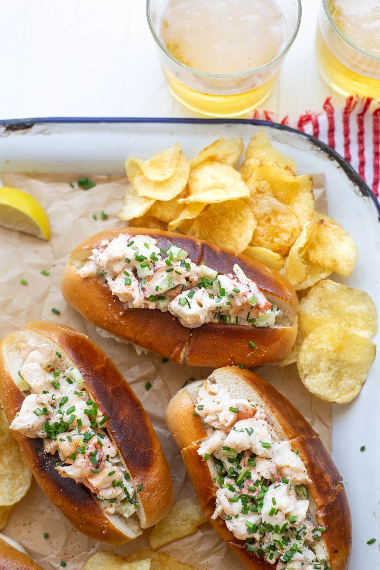 Grilled Cajun lobster rolls being served on a platter.
