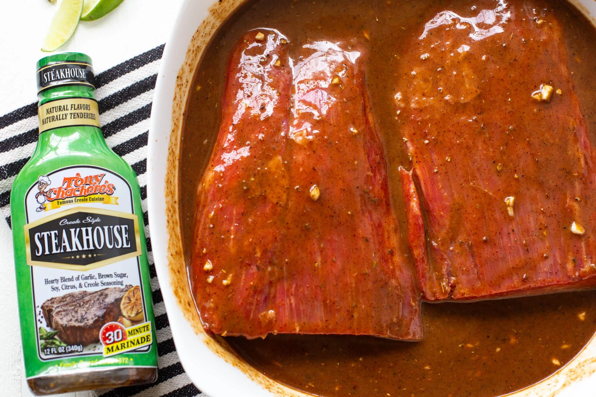 Flank steak marinating to grill carne asada tacos.