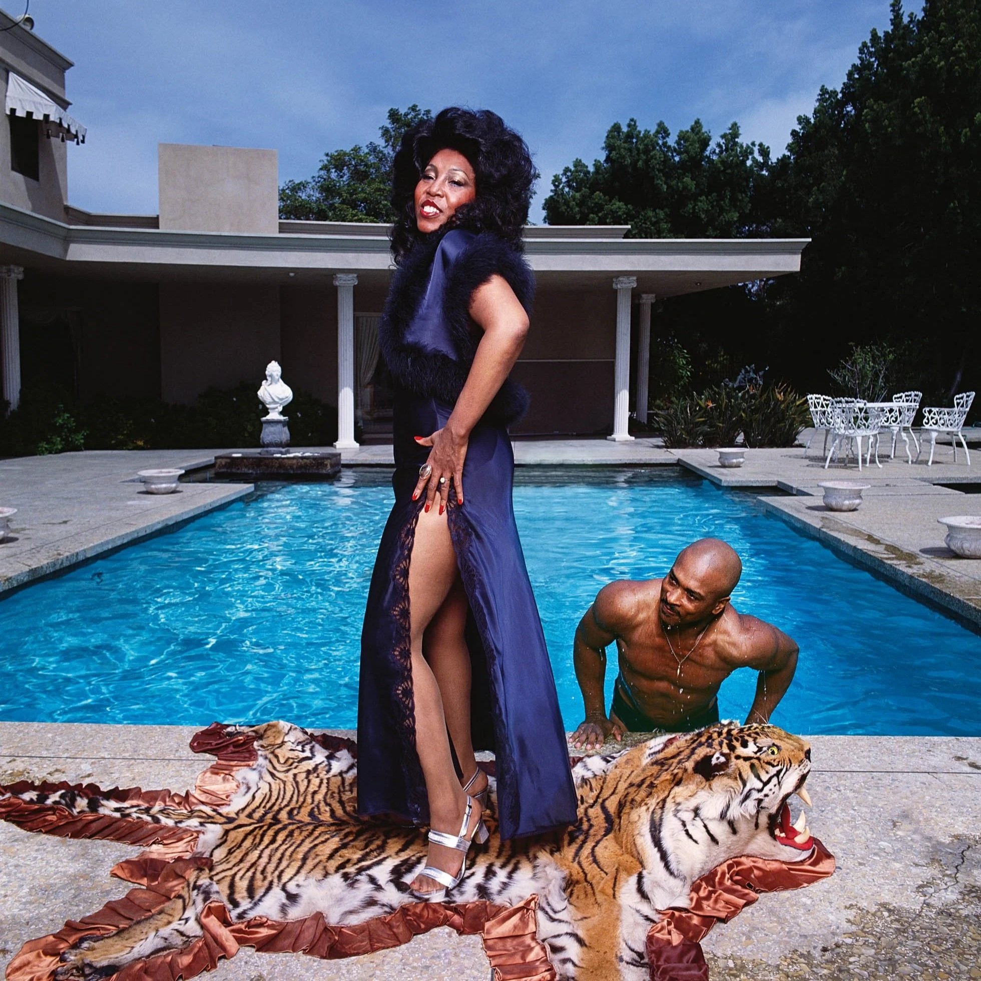 Denise LaSalle standing on a dead tiger rug in front of her pool