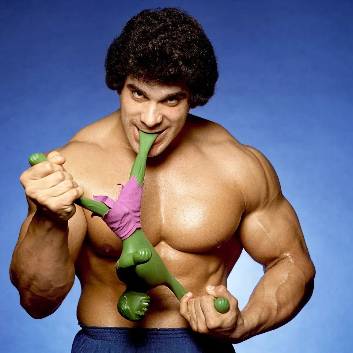Lou Ferrigno pulling apart a hulk action figure with his teeth in 1979