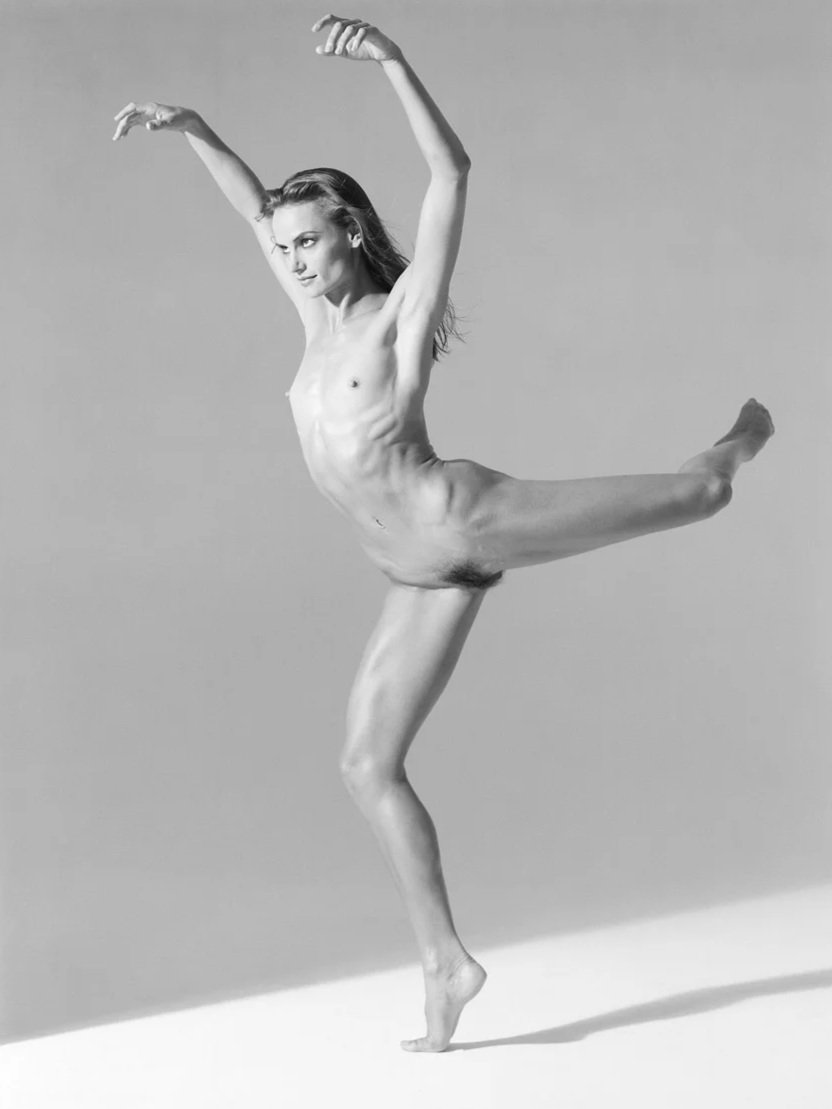 A nude woman does a scorpion dance pose