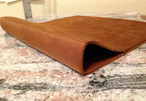 7 : The leather is cleaned up around the edges, marked with chalk to the correct size and hammered into shape.