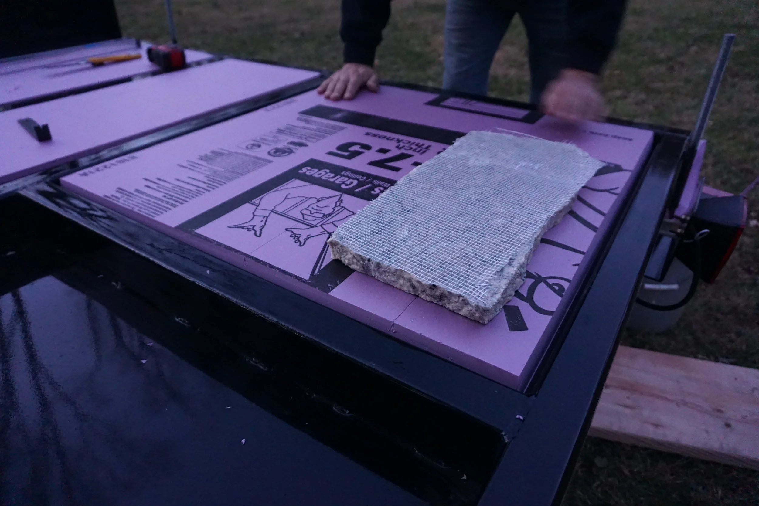 Using granite to hold down the rigid insulation.
