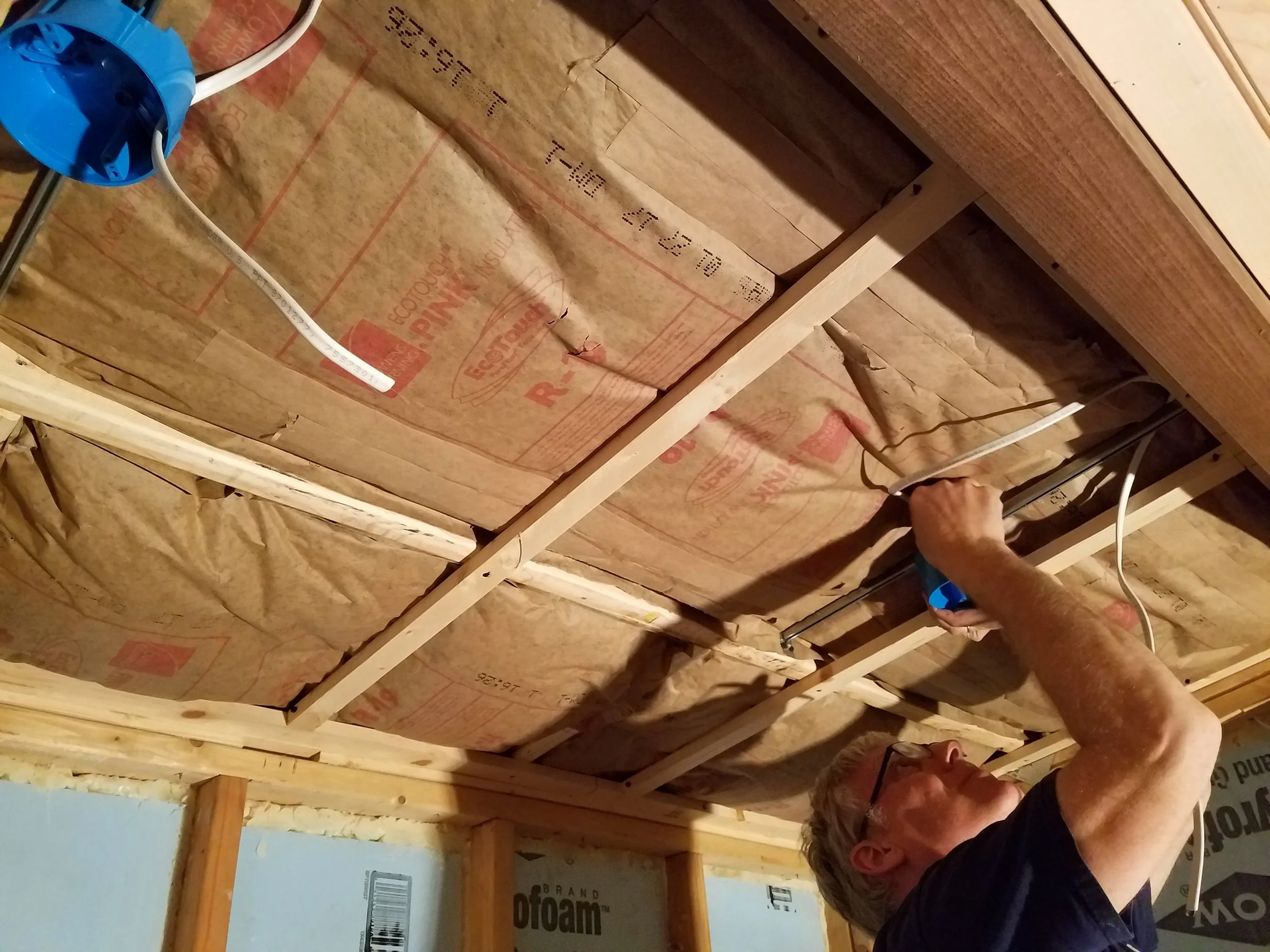 Running all the wire to the ceiling lights before closing off the ceiling.