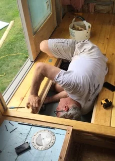 The exterior receptacle location needed to be relocated so the wire was run through the storage area under the floor. A tight fit, Eric (aka Dad) squeezed a tad to be able to secure the wire to the new location.
