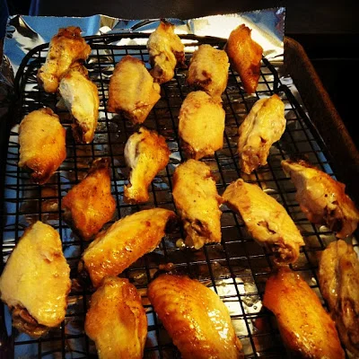 Pre-sauced wings before their trip under the broiler.