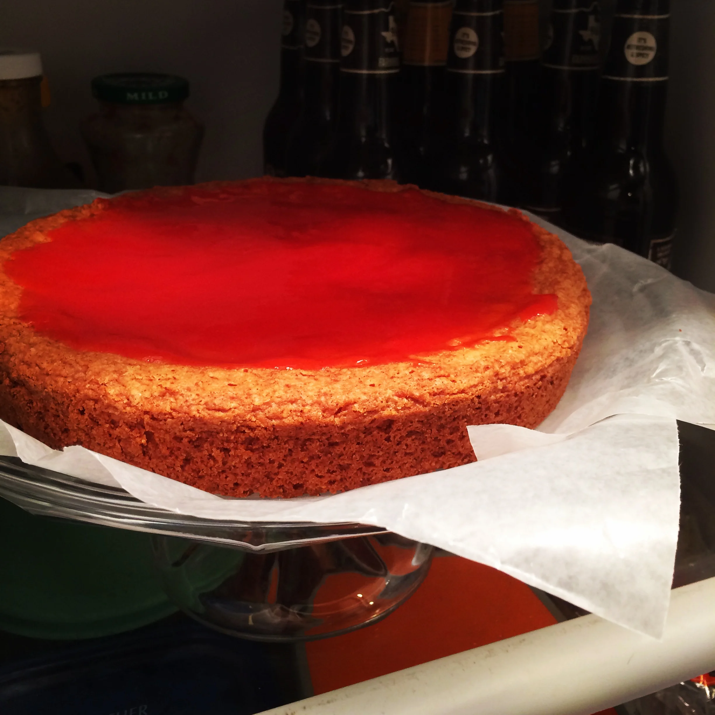 Strawberry lemonade jam setting up on the lemon layer cake.