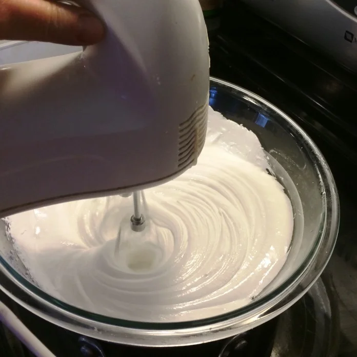 Whipping the frosting.&nbsp;