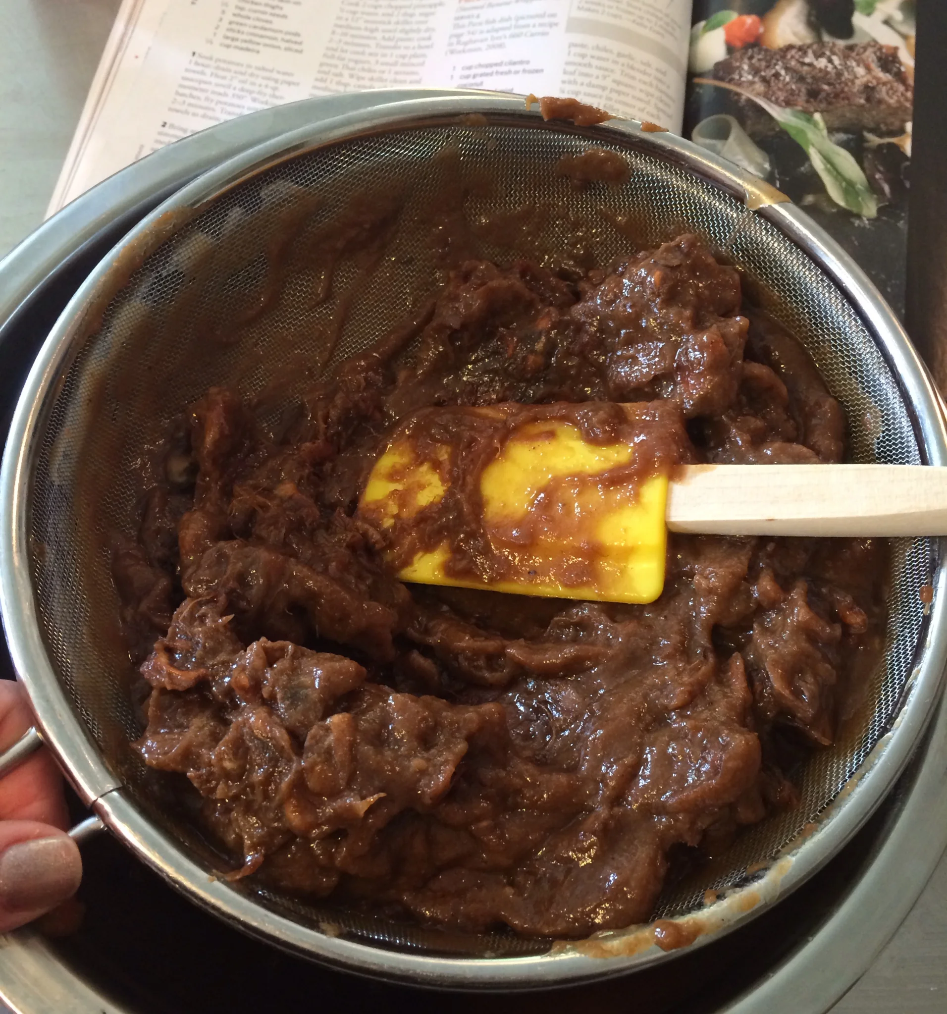 Straining out the tamarind pods to make tamarind paste.