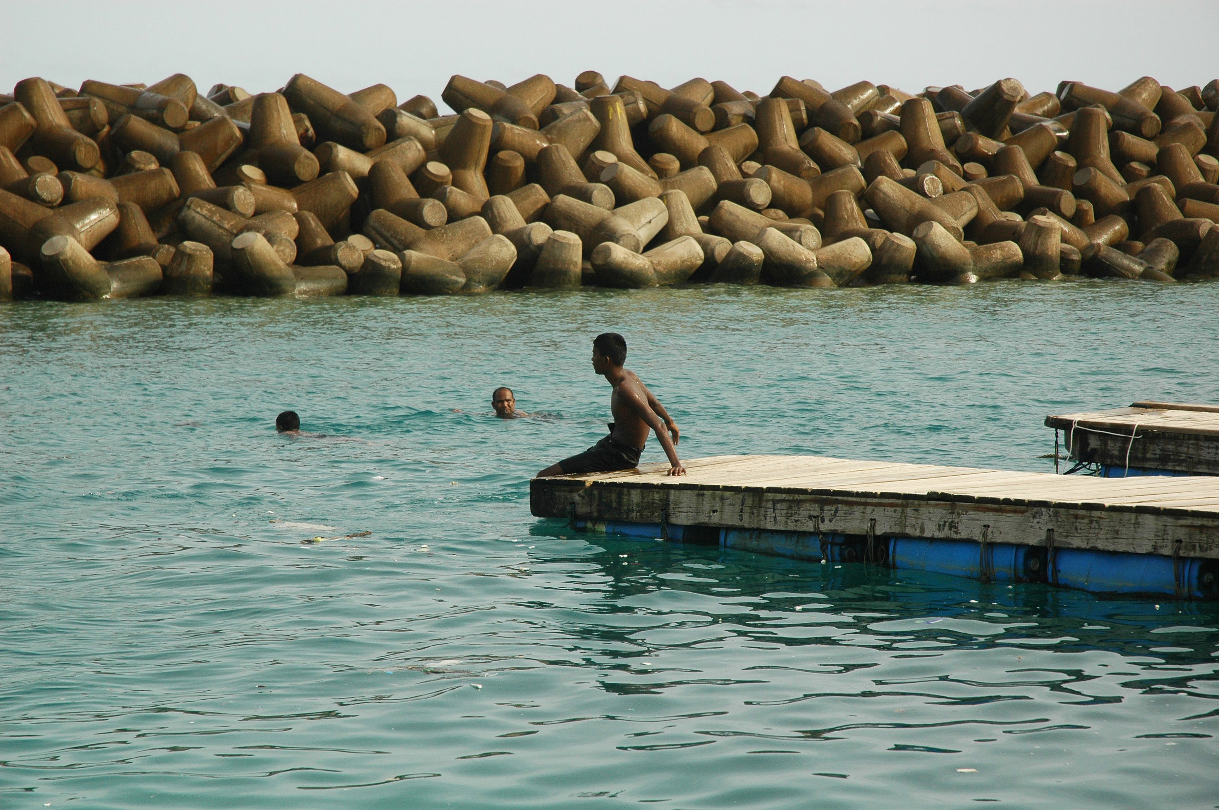 Boy sits at the edge of one of the older iterations of the swimming platforms. Nikon D70s (2007)