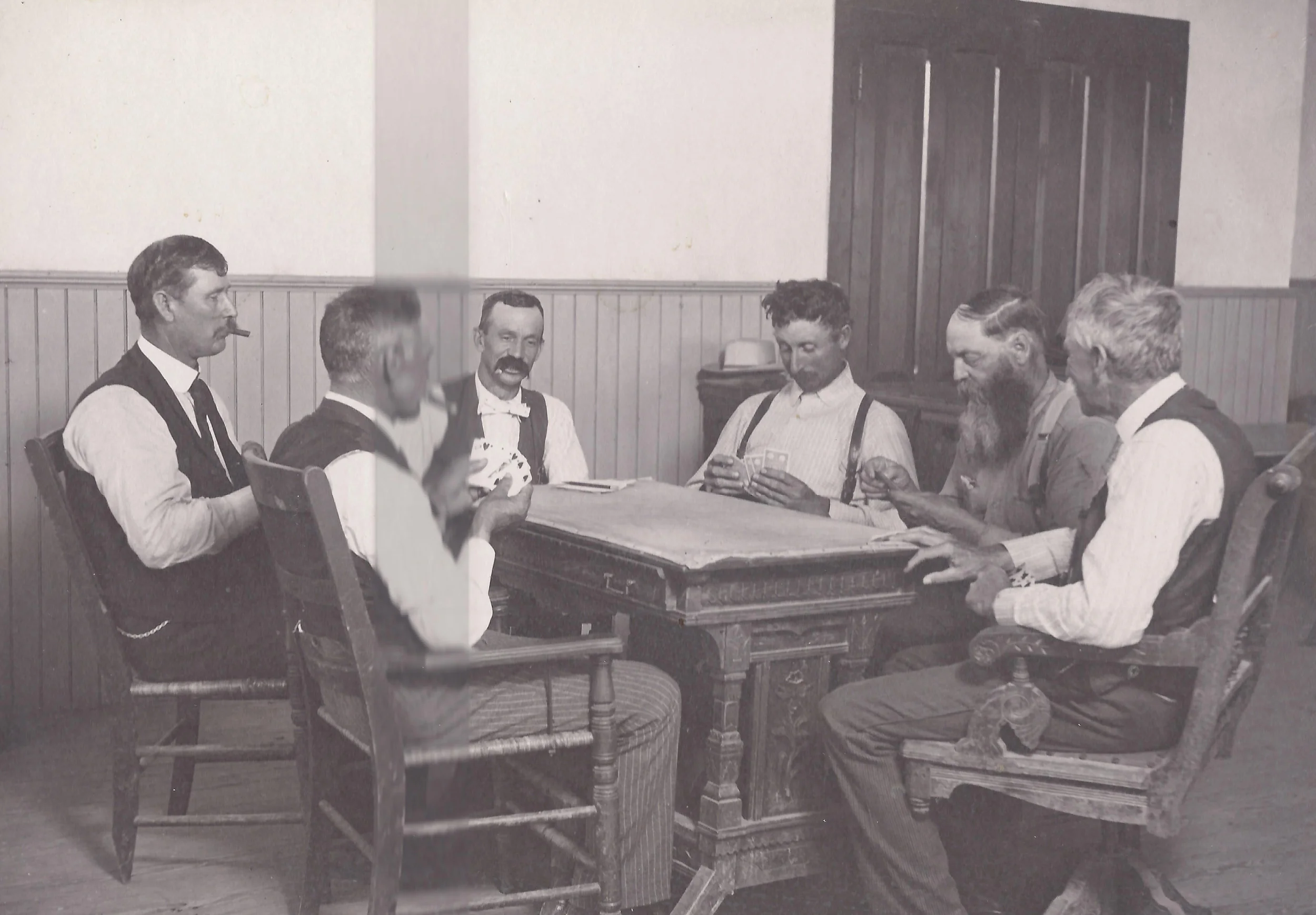 A game of pitch in the courthouse at Santa Fe, Kansas. From L-R, V.L. Bethel - county official, F.E. Murphy - county treasurer, James Patrick - Abstractor, Henry Johnson - county commissioner, George Wallace - probate judge and Mr. Ballentine.
