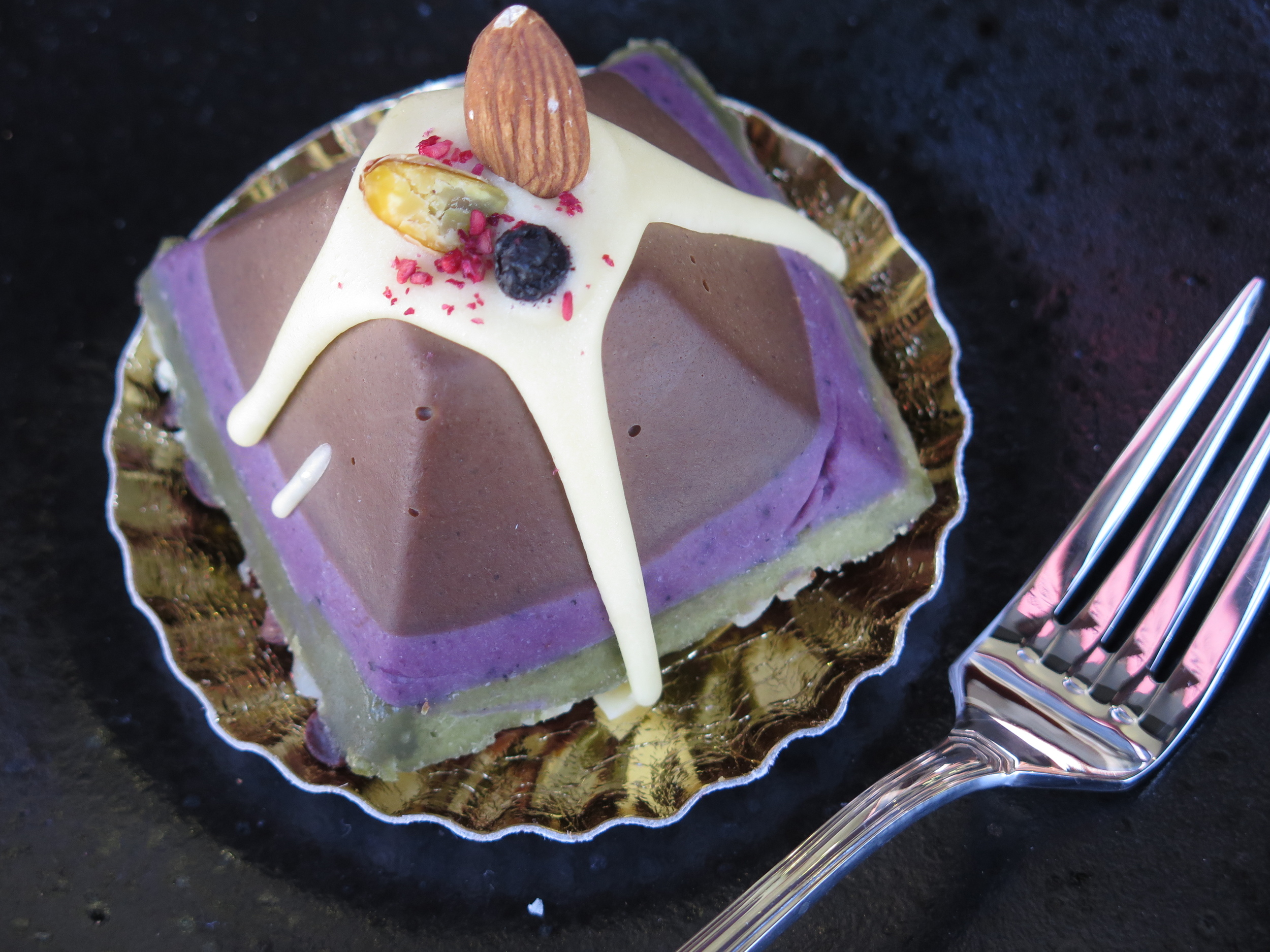 Raw Pyramid Cake with Chocolate, Berry, and Pistachio Mint Layers