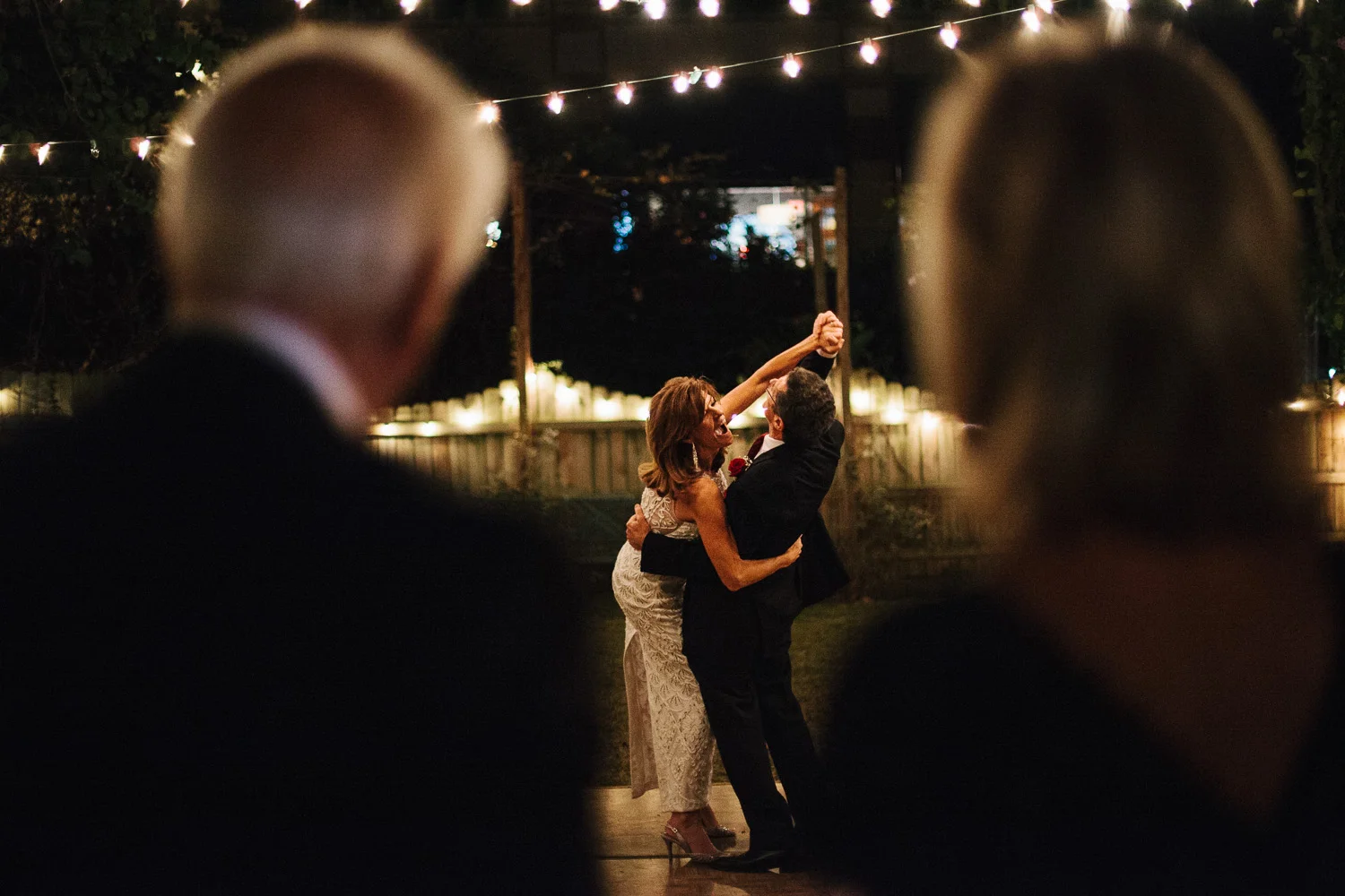 Bride and groom have an exciting first dance while their parents look on in Orlando Florida