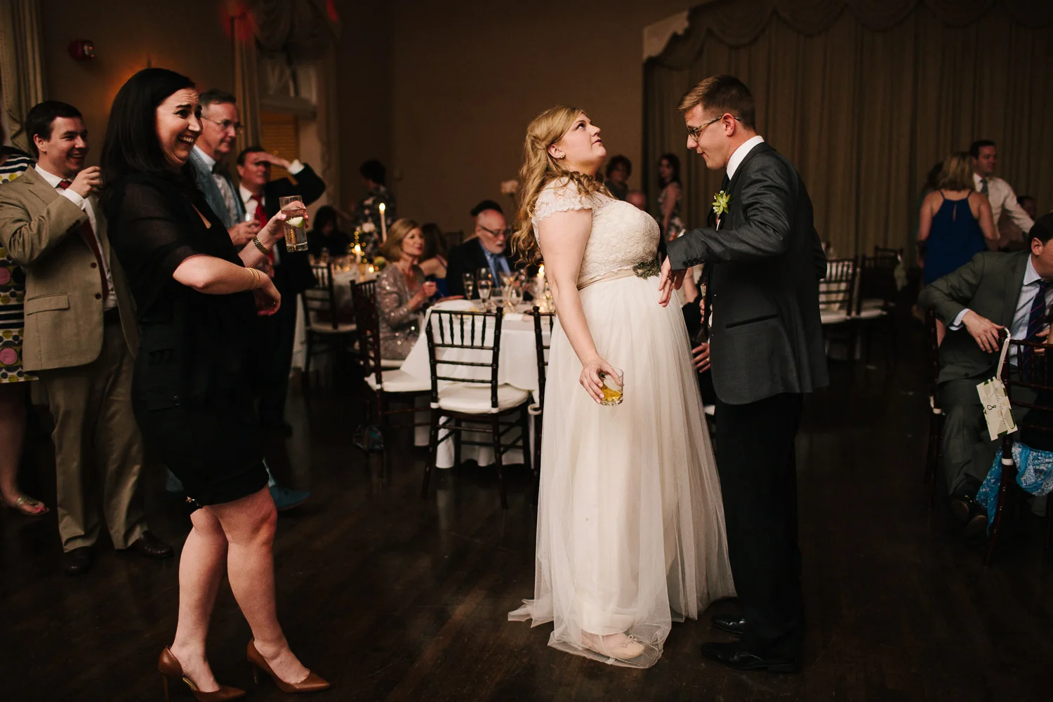 Bride and groom dancing together while guests look on at their reception at the Florida Yacht Club in Jacksonville