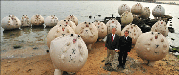 Here the Yes Men display "Survivaballs," created by corporations for people to wear when the climate change makes the planet otherwise unlivable. The Survivaballs floated over the East River to the UN where the Summit on Climate Change was commencing.