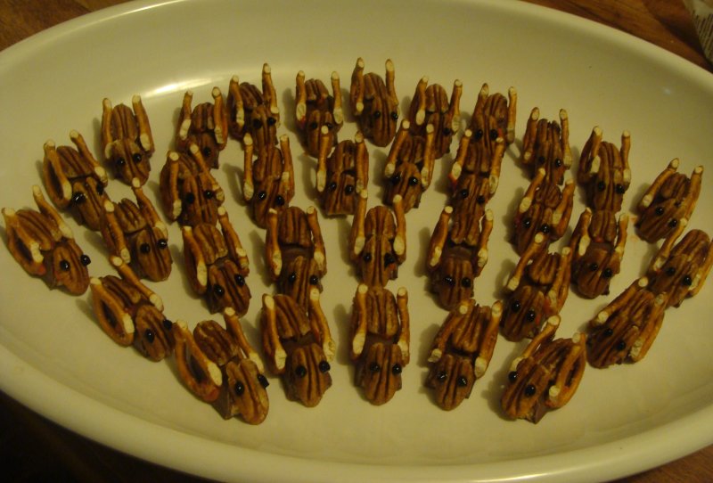 Cleverly concocted with pecans, pretzels, halved Twix candy bars, and glue made of sugar and water. Dabs of black frosting for the eyes.