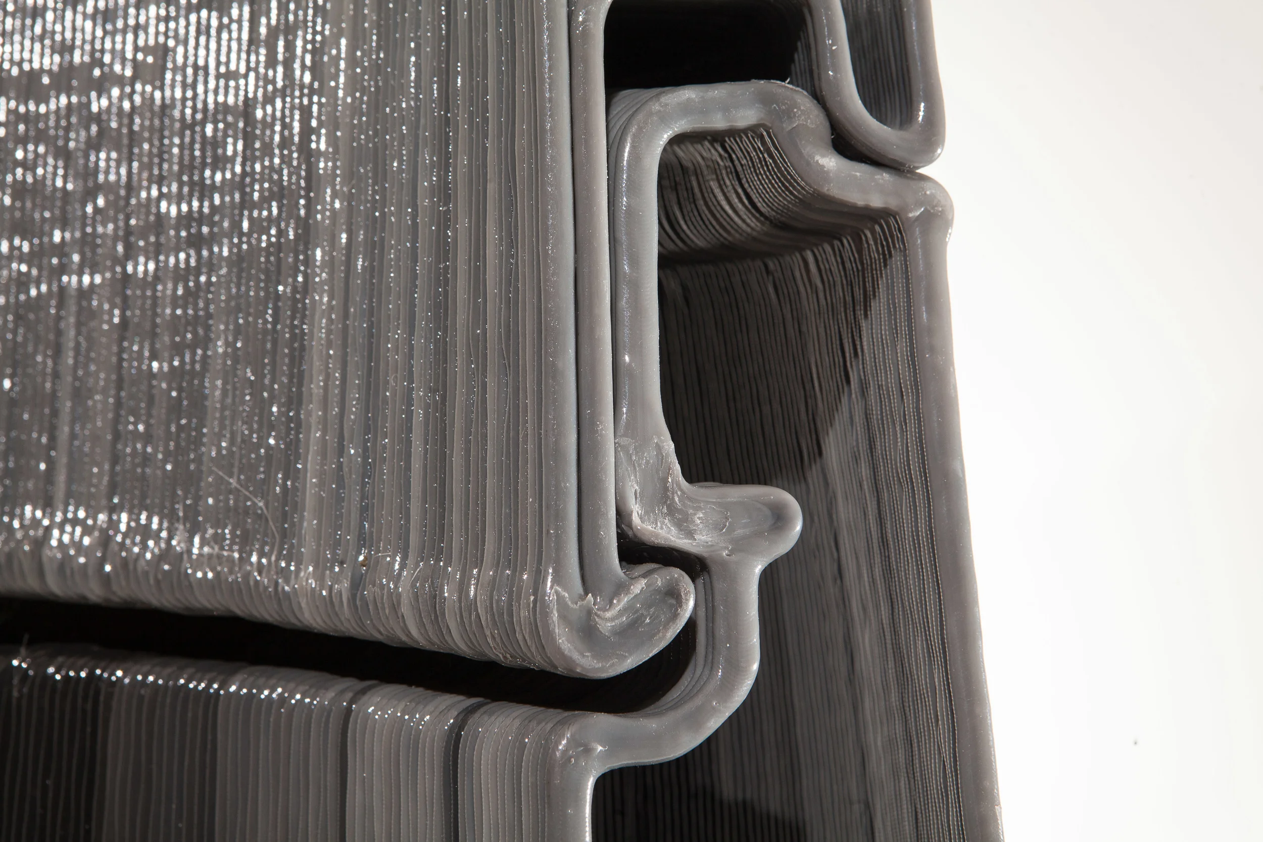  Detail view of s-wall connection. This detail was designed to have a tension element on the outside of the building (hook and matching receptacle left center) and a compression element on the inside. The joint is simply disconnected by reversing the