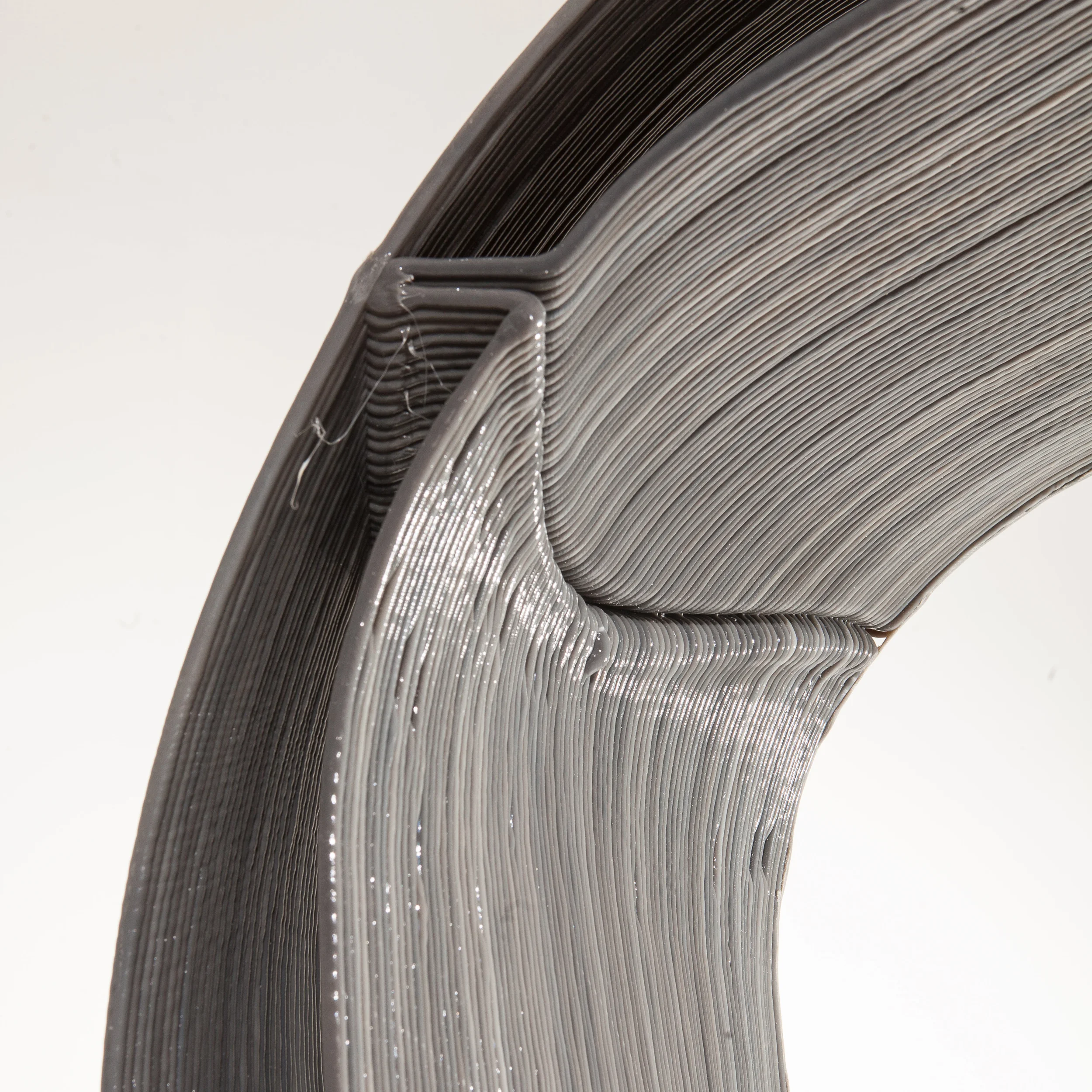 By curving the web connection in elevation and rotating it along its length the web is acting in multiple planes simultaneously - greatly increasing it rigidity while minimizing the use of material and reducing the print time.