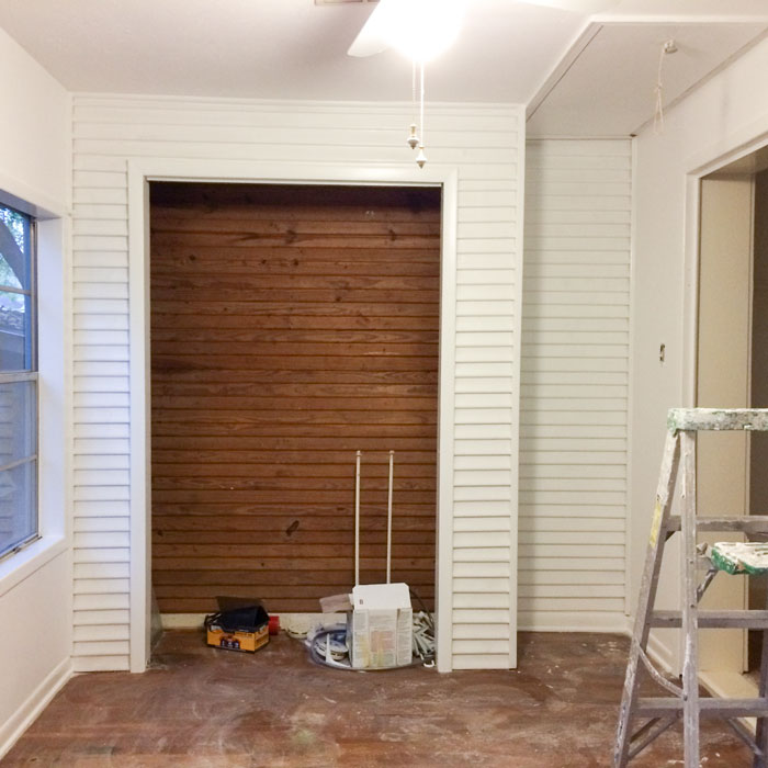 This back wall used to be the back of the house, and we think part of this room was once a back porch. Part of this section was already painted but I had the painters leave the part that wasn't. I loved the color of the wood and how it warms up the wall. 