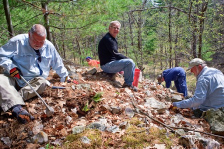 Bill Plavac wields a mean "gem scoop" while Doug Dingeldein (right) supervises and Don Caldwell feigns surprise. Dick Stata, as usual, is busy at work getting the best specimens.