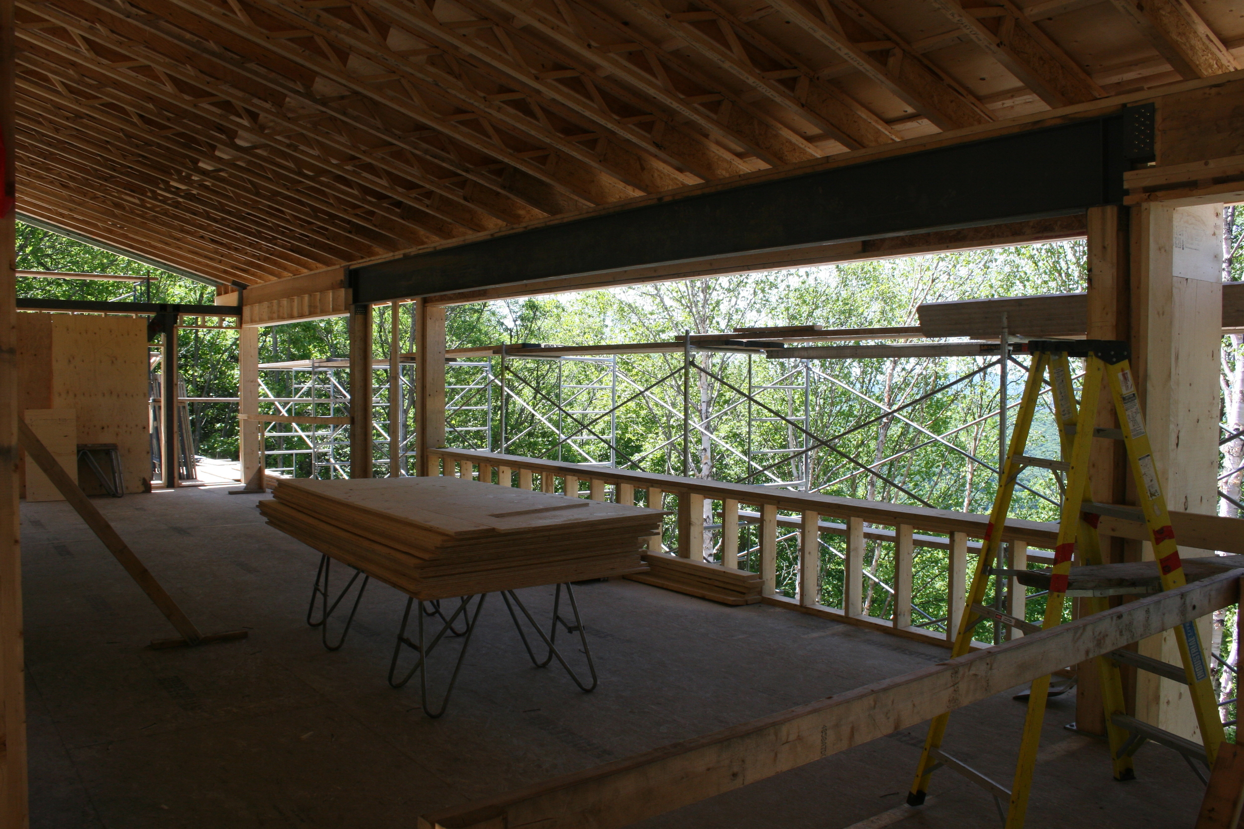 View of tree tops thru 27' bay window, with Lac Archambault below...