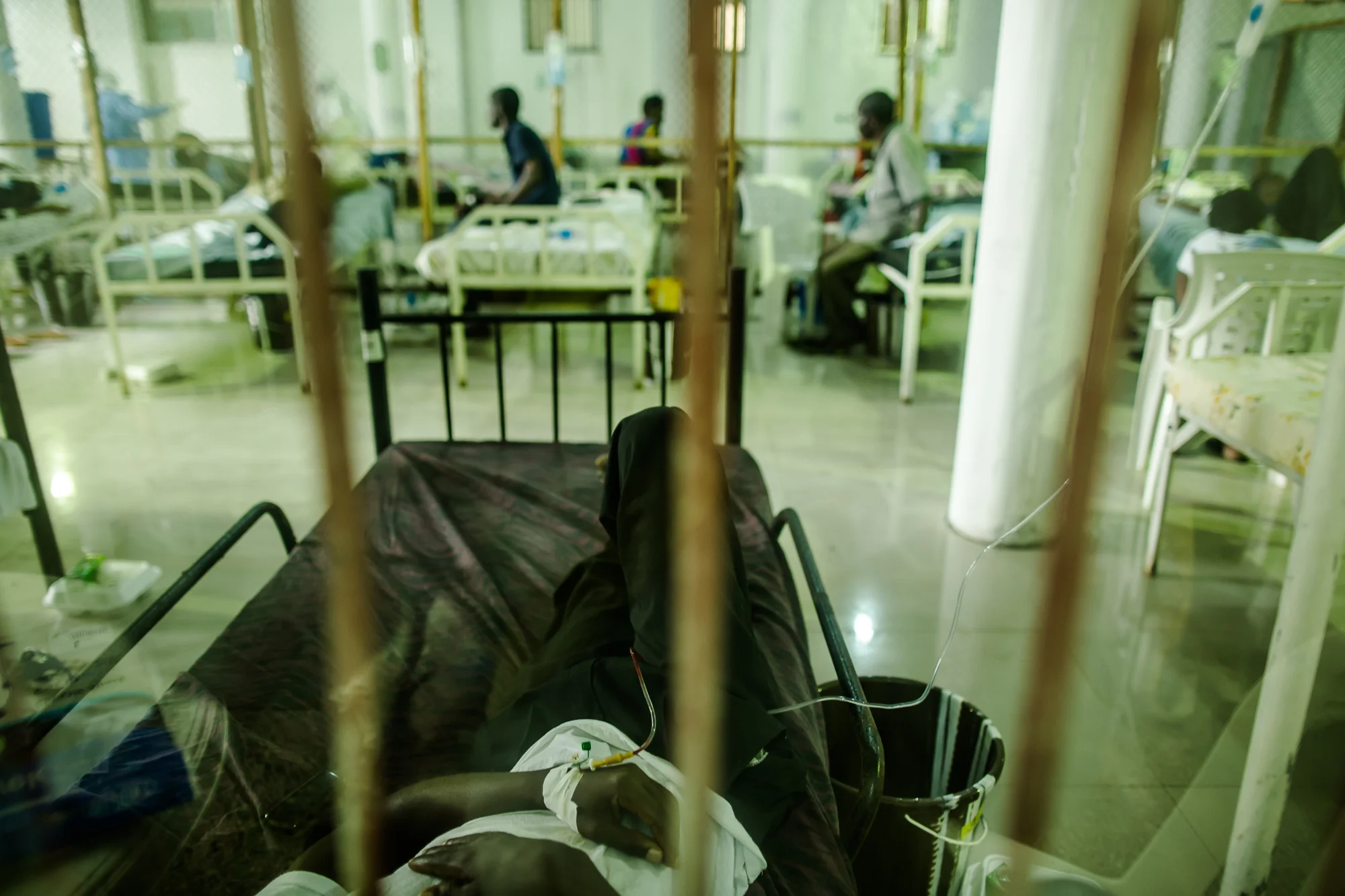  Monrovia, Liberia - September 22, 2014: A patient admitted to the Ebola treatment unit at Island Clinic resting in his bed connected to an IV. IV's were a controversial component of treatment during the outbreak because of the increased&nbsp;risk of