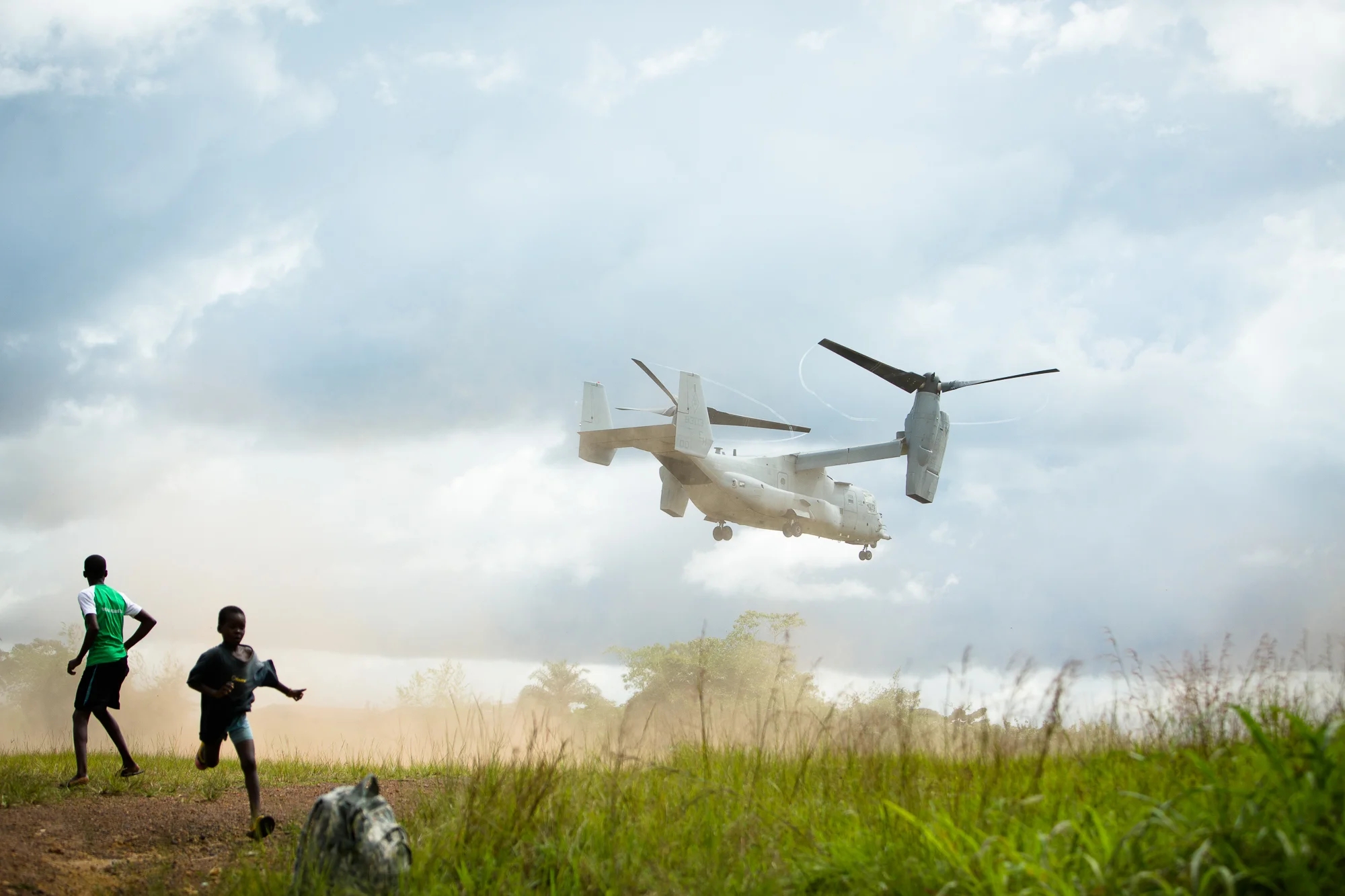  Tubmanburg, Liberia - October 15, 2014: &nbsp;Liberian children run as a U.S. Marine V-22 Osprey lands in Tubmanburg. Photo by Morgana Wingard 