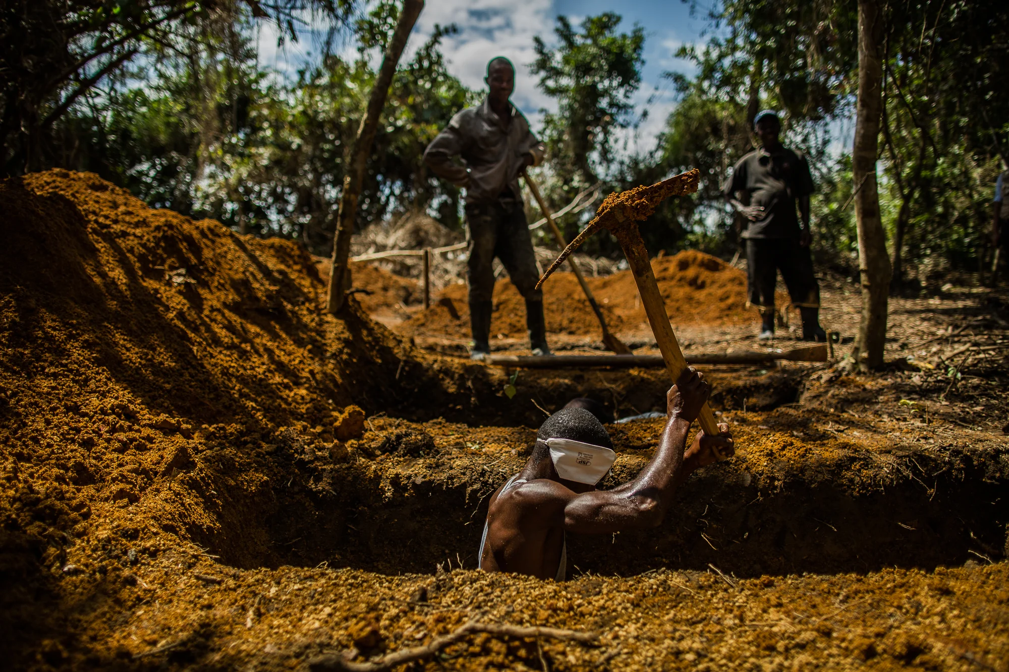  Suakoko, Bong County, Liberia - October 7, 2014: &nbsp;Grave diggers at the International Medical Corps Ebola treatment dig graves for patients who die of Ebola. Every body is buried in a sealed bag and the area is sprayed with chlorine. The graveya