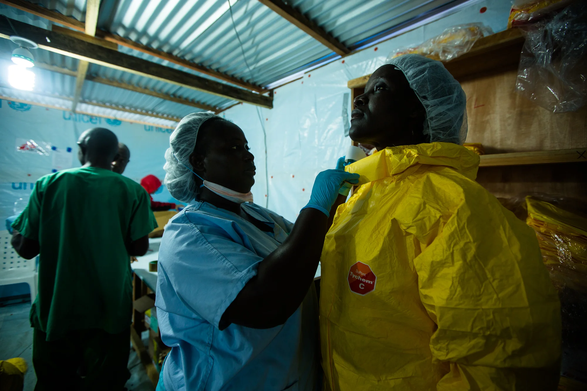  Monrovia, Liberia - Aug 30, 2014: &nbsp;Agnes, a member of the Psychosocial Team dresses in her Personal Protective Equipment (PPE) to prepare to enter the hot zone at ELWA 3 —  the Ebola treatment unit (ETU) run by Doctors Without Borders (MSF). Ag