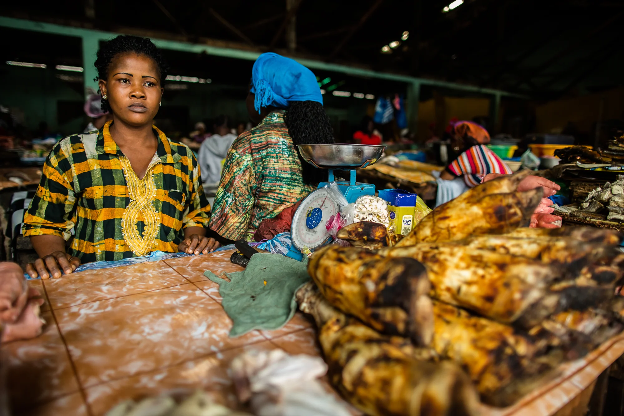  Monrovia, Liberia - September 18, 2014: Ama and Oretha sell meat in Waterside Market. Since the Ebola outbreak and the quarantine of West Point their sales have plummeted. With the cost of transport and goods going up and sales going down they are m