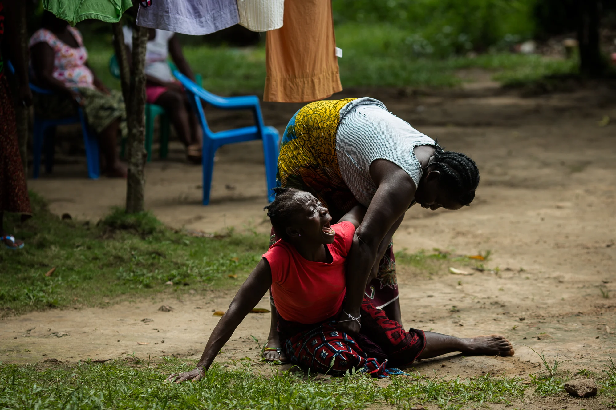  Monrovia, Liberia - September 26, 2014: A neigbhor&nbsp;cries as a burial team arrives to remove the body of her friend&nbsp;suspected to have died of Ebola. Photo by Morgana Wingard 