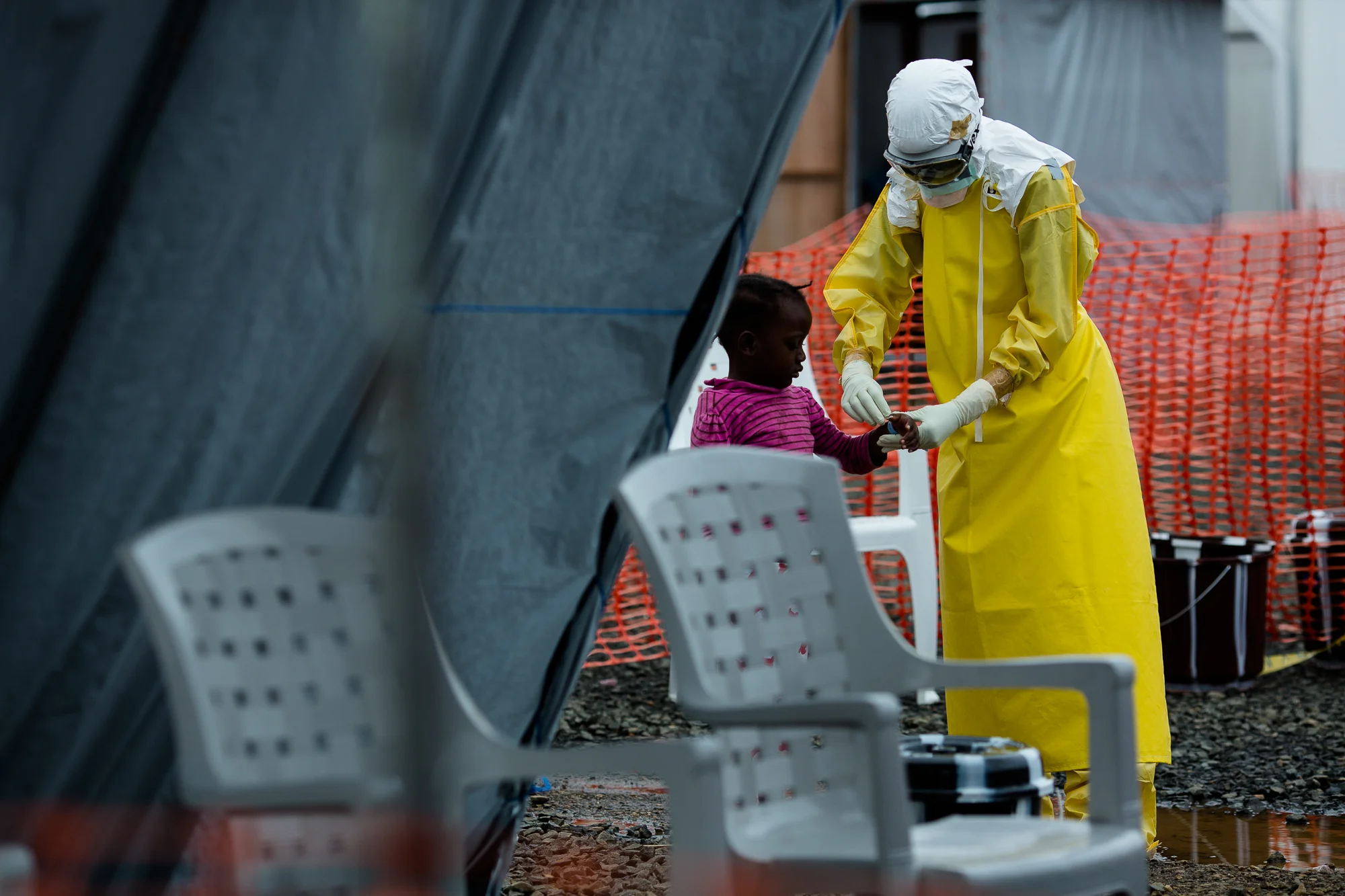  Monrovia, Liberia - Aug 33, 2014: &nbsp;An Doctors Without Borders (MSF) staff member in the triage unit, admits a young girl who arrived at ELWA 3 in an ambulance by herself. ELWA 3 &nbsp;is the Ebola treatment unit in Monrovia&nbsp;run by MSF. Pho