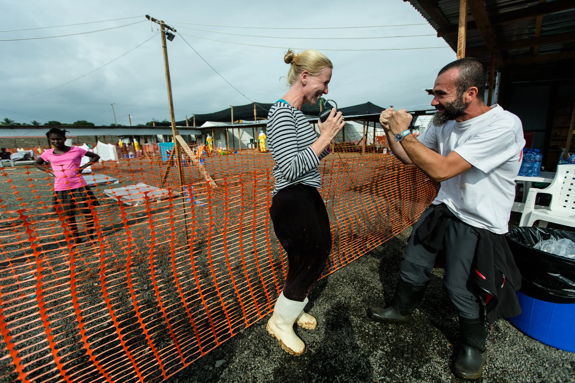  Monrovia, Liberia - Aug 33, 2014: Sissel Overvoll and Dr. Roberto Scaini jump for joy as eight patients prepare to be released from ELWA 3 —  the Ebola treatment unit run by Doctors Without Borders in Monrovia. &nbsp;Photo by Morgana Wingard 