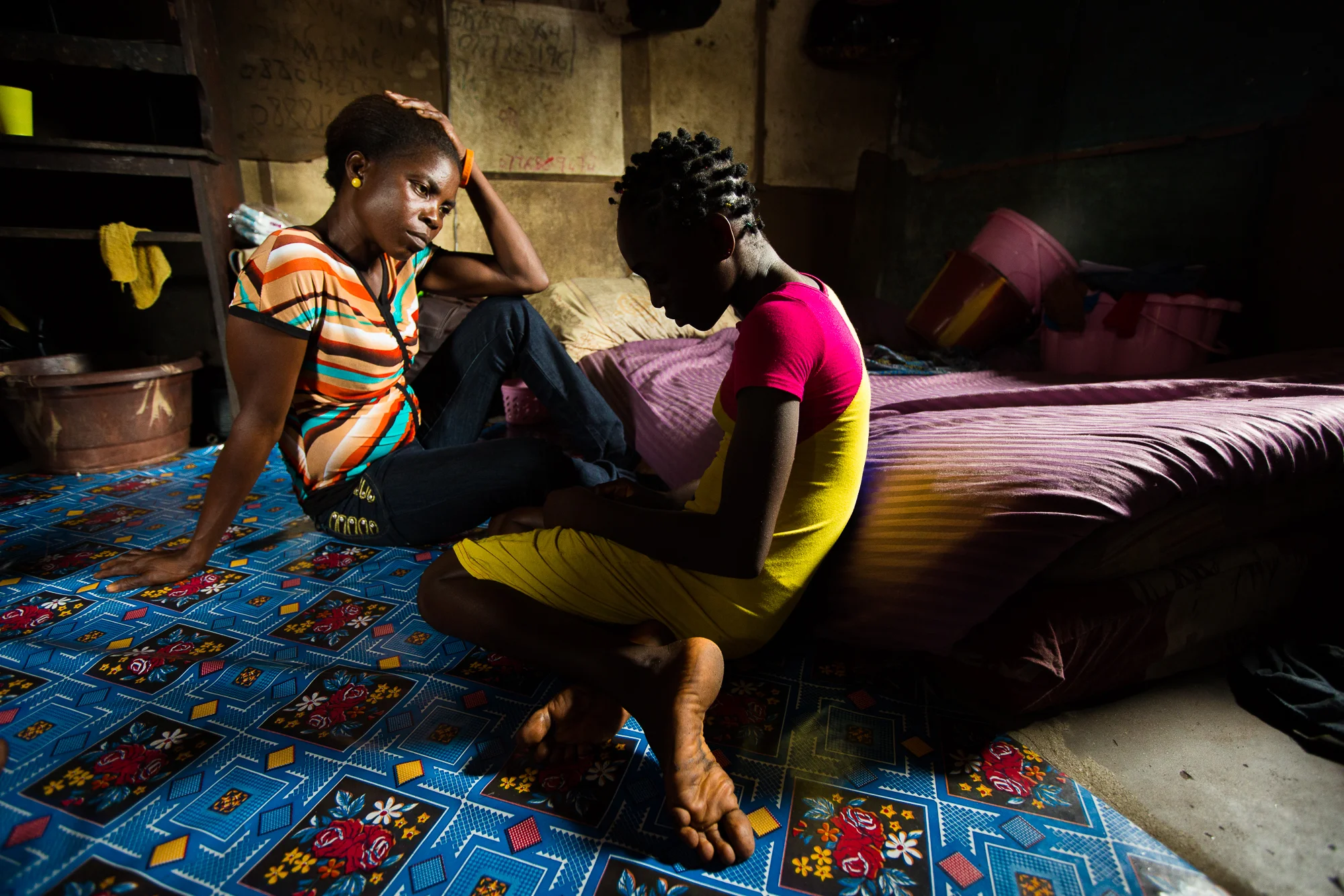  New Kru Town, Monrovia, Liberia - June 4, 2014: &nbsp;Martha Wieh, a rape survivor, in her home in New Kru Town in Monrovia, Liberia with her mother, Elizabeth Ponney. Photo by Morgana Wingard 