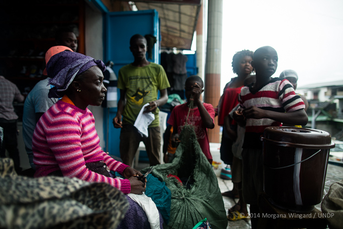  Anne Benson, 49, sells used clothes in Waterside Market to support her nine children and five grandchildren in Monrovia on September 18, 2014. She lives with her husband and children in Sinkor. Since the Ebola outbreak her sales have plummeted. She 