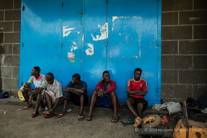  Vincent, 24 (center, in blue) and Junior, 20 (middle, in red), both residents of West Point, atownship that has been one of the hardest hit by the Ebola epidemic, used to drive motorcycles for a living — a form of local transport in Liberia used lik