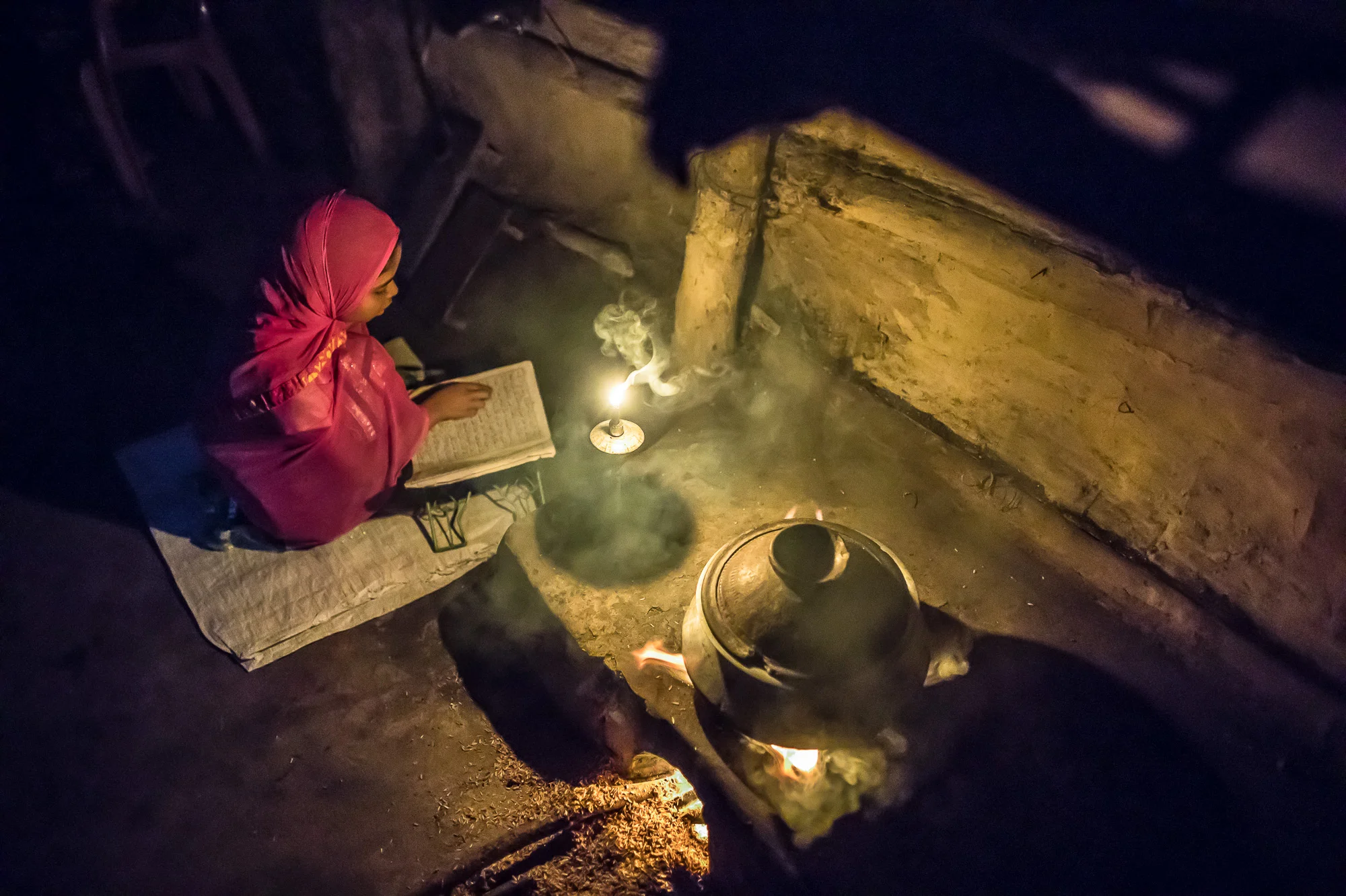 COX'S BAZAR, BANGLADESH: October 25, 2016 - Joynur Jahan Joba, 10, reads the Koran in the morning before going to school. Photo by Morgana Wingard