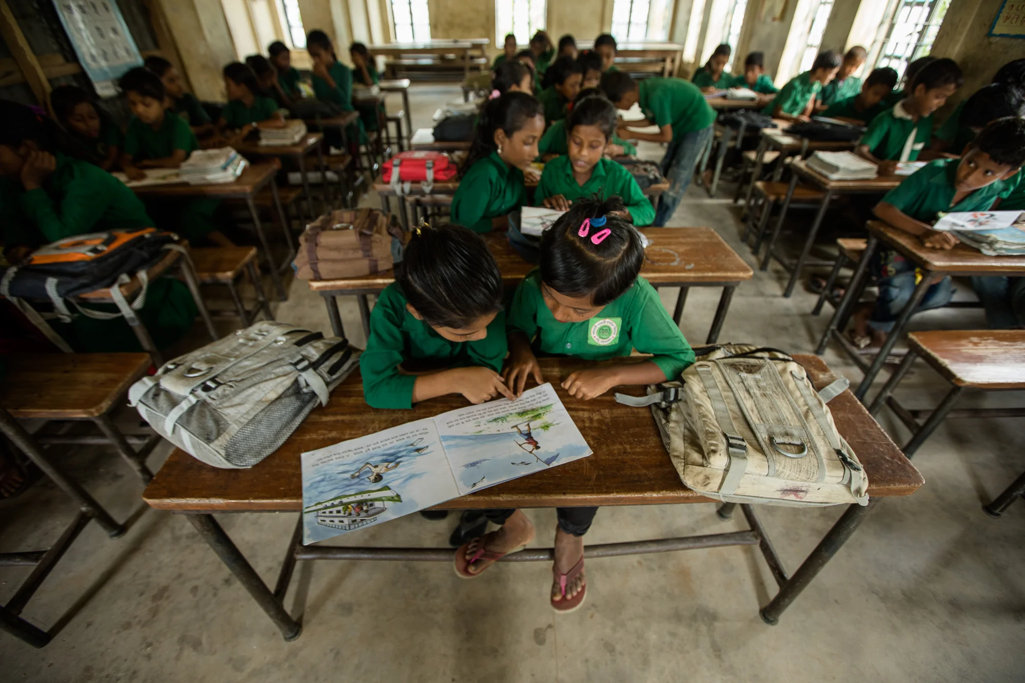 COX'S BAZAR, BANGLADESH: October 25, 2016 - Joynur Jahan Joba, 10, is one of many students in Bangladesh who have improved their reading skills thanks to the Reading Enhancement for Advancing Development (READ) project. READ is a 4-year collaboration with Save the Children International to improve early grade reading competence. Learning to read affects all aspects of children’s education. By ensuring a strong foundation at the beginning of school, the expectation is that fewer children will repeat grades or drop out in the primary cycle. A higher proportion will hopefully complete school with solid primary school skills–such as literacy–which are critical life skills in today’s world. Photo by Morgana Wingard