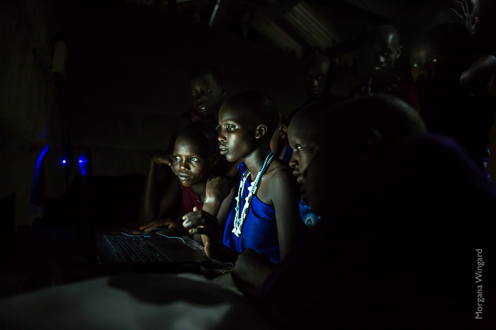  ESILALEI, TANZANIA - FEBRUARY 4, 2014:  Through the creation of solar powered micro-grids, Maasai of the Moduli district in northern Tanzania are receiving power in their mud huts inside their bomas (corralled community). The solar power is providin