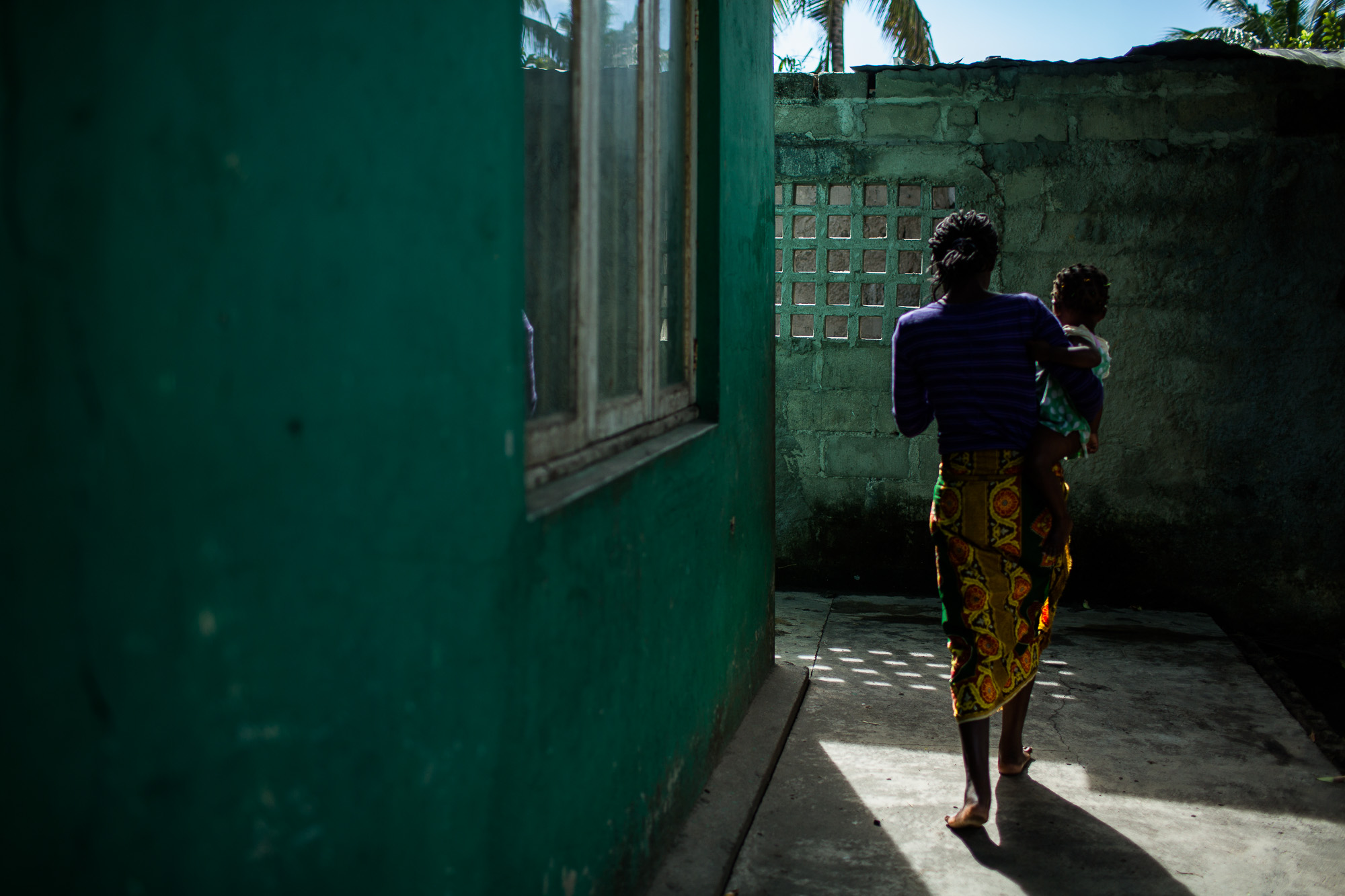 BEIRA, MOZAMBIQUE: July 5, 2016 - Aida Samuel, 29, lives in the Mascharinha neighborhood of Beira with her 5 children. A skeleton of an old van decomposes in the yard as her children run around with others from the neighborhood. The old tires, garbage and crumbling cement inside the walled compound serve as a playground. Inside her simple cement house, Aida watches TV with the kids. Their favorites are Brazilian novellas. This is how they pass most of their days -- watching tv and playing in the yard. Then at 5pm Aida heads into town where she looks for work. She hangs around bars with other women looking for men who want to pay for sex.
Aida turned to commercial sex work when she was 23. With three children and no husband she had no way to support her family and send her kids to school. No one was helping. A friend suggested she try it — that’s how many other girls in her neighborhood support themselves.
Clients come from all over. The city is known for having girls so men flock there. It's the beginning and end of the “Corridor,” a busy trade route used by truckers hauling goods throughout Southern Africa so many of their clients are truck drivers from Malawi, Zimbabwe and other countries in the region.
Once she has a customer they start negotiating the price and discuss condoms. The more time, the more money. It's typically 100 Meticas (1.45 Euro) for 5 minutes. She then takes her client to a nearby room that she rents for 20 Meticas. Most of the time she provides her own condoms supplied for free from MSF. Sometimes the men bring their own but they've been known to poke holes in them so she doesn't trust them. Nowadays she only works 3 days a week from 5pm - 8pm.
She used to work 6 days a week, but now she's not feeling as strong as she used to. Last December (2015) she started to feel sick. It started with a fever. She went to the hospital to be tested. At first she came up negative for everything. Eventually they diagnosed her positive for HIV