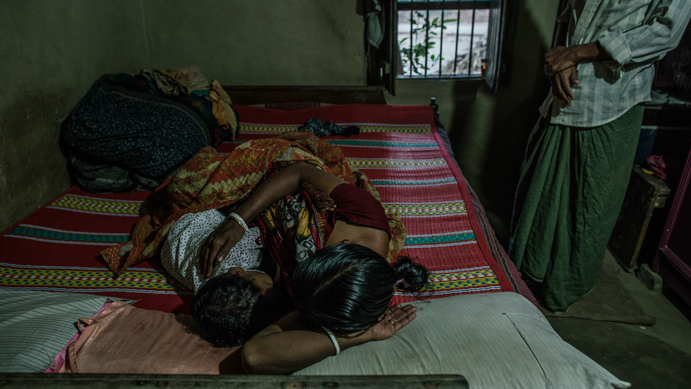  Supriya Dae (mother) and her husband, Rotonu Dey, wake up their son, Ornoy Dey in the morning. 