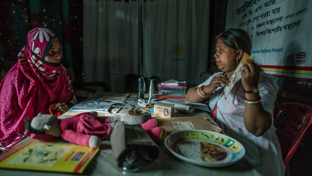  Shanta Das, a paramedic at Smiling Sun Clinic, consults pregnant mothers in a satellite clinic 