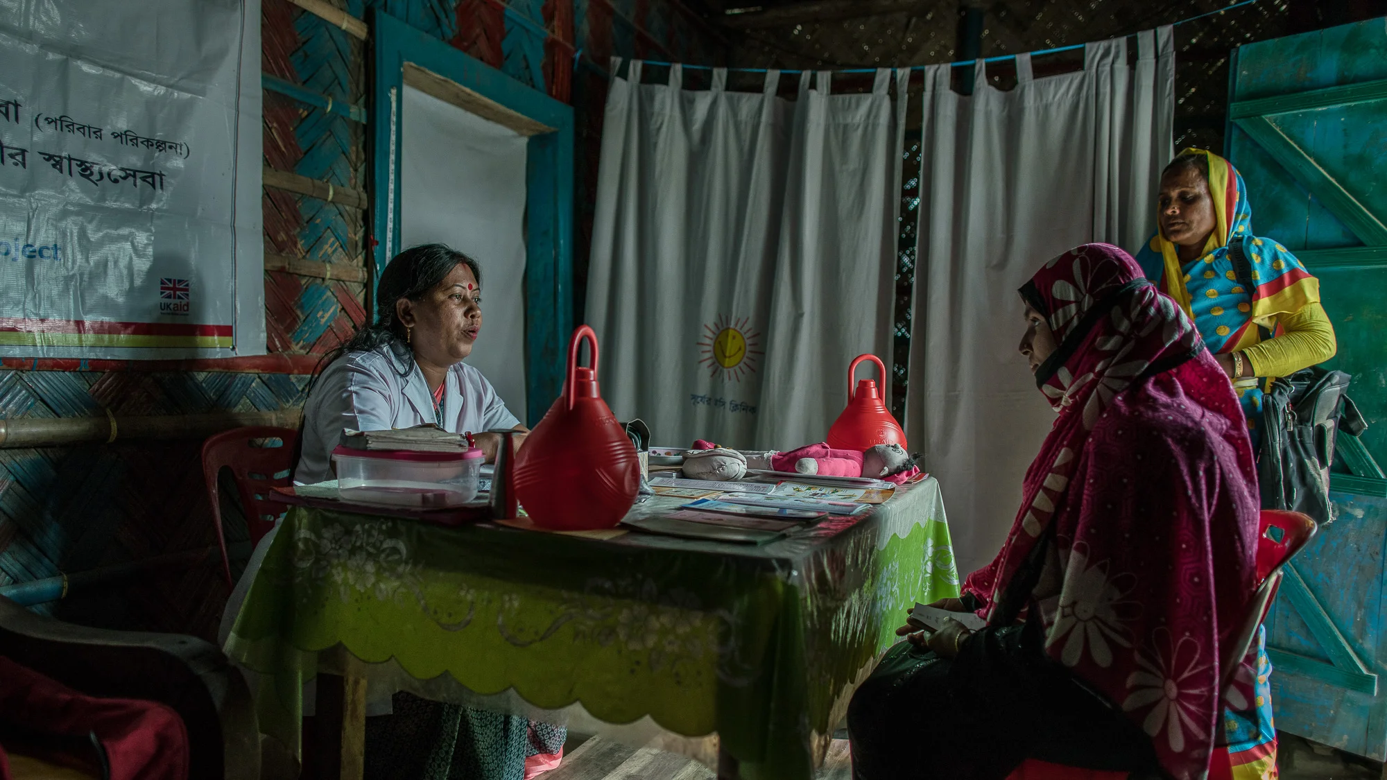 Shanta Das, a paramedic at Smiling Sun Clinic, consults pregnant mothers in a satellite clinic.