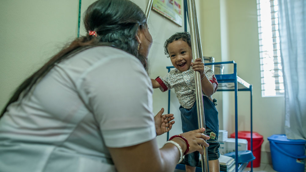  Supriya Dae and her son visit paramedic, Shanta Das, for a checkup on his growth.&nbsp; 