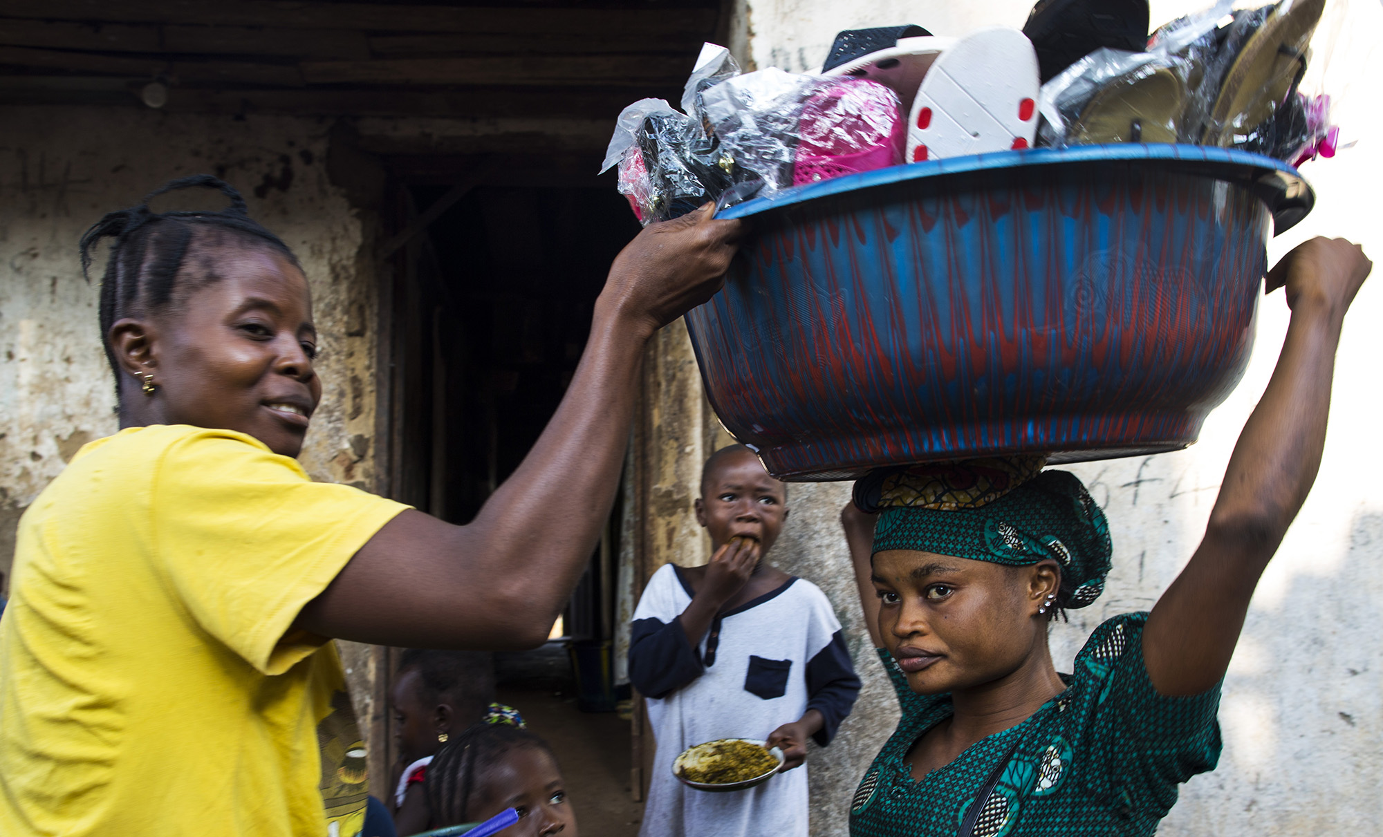  Mariatu Bangura, 18, of Rokupr, sells slippers to help provide for her son and herself.&nbsp;    