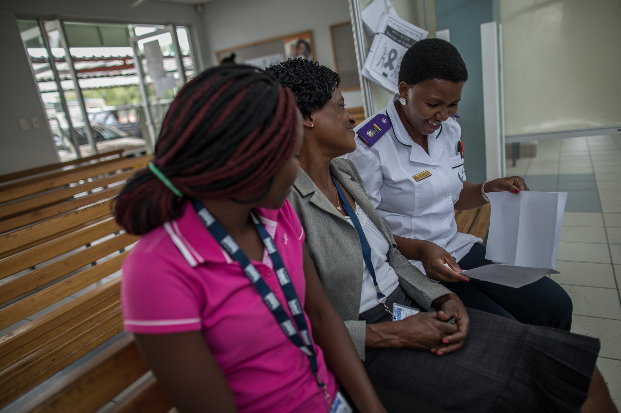 Loide Likuyu (center) talks with health workers at Shanamutango HIV clinic at Onandjokwe Hospital, Namibia. 